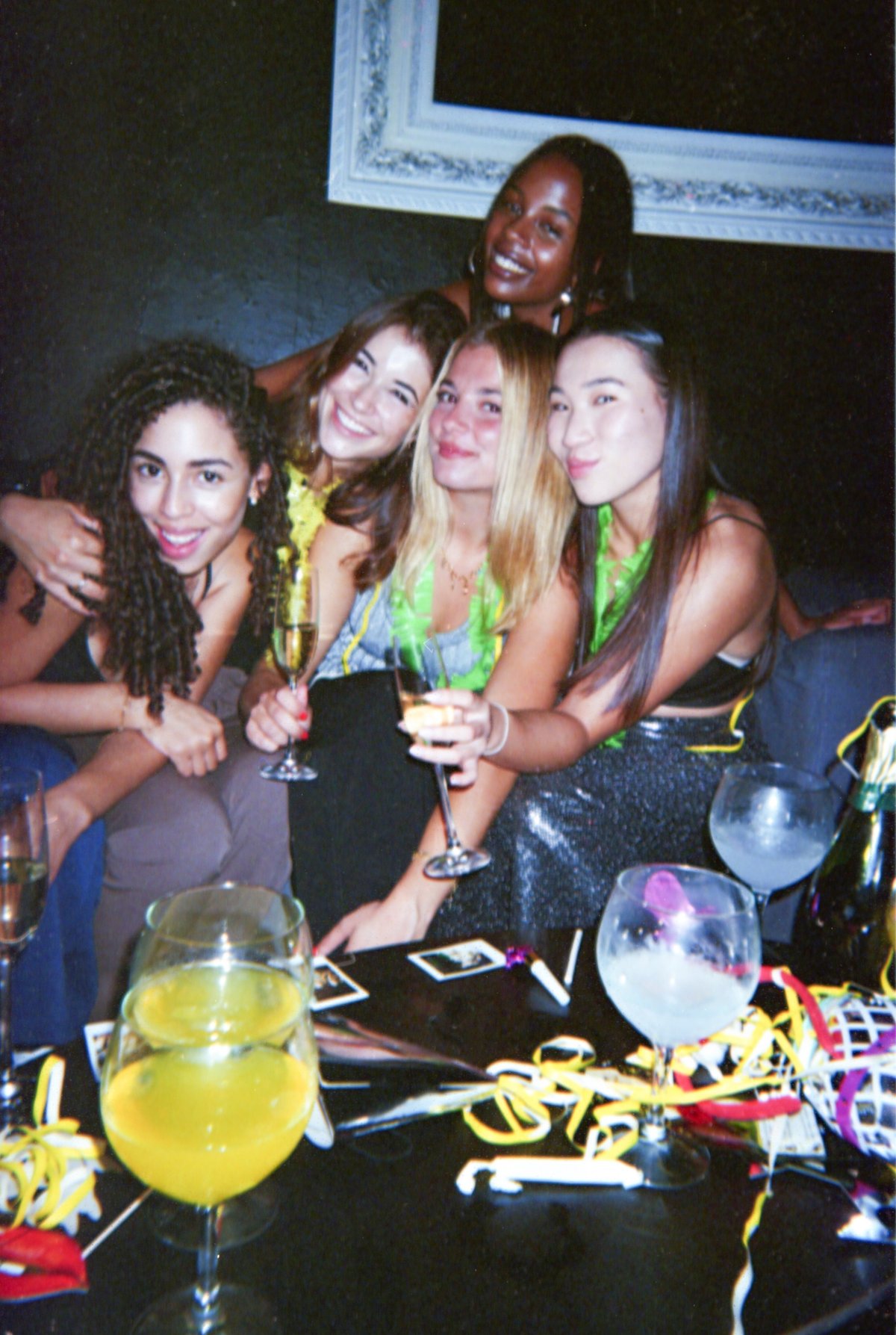 A lively group of friends enjoying a night out at Taboo, celebrating with drinks and music